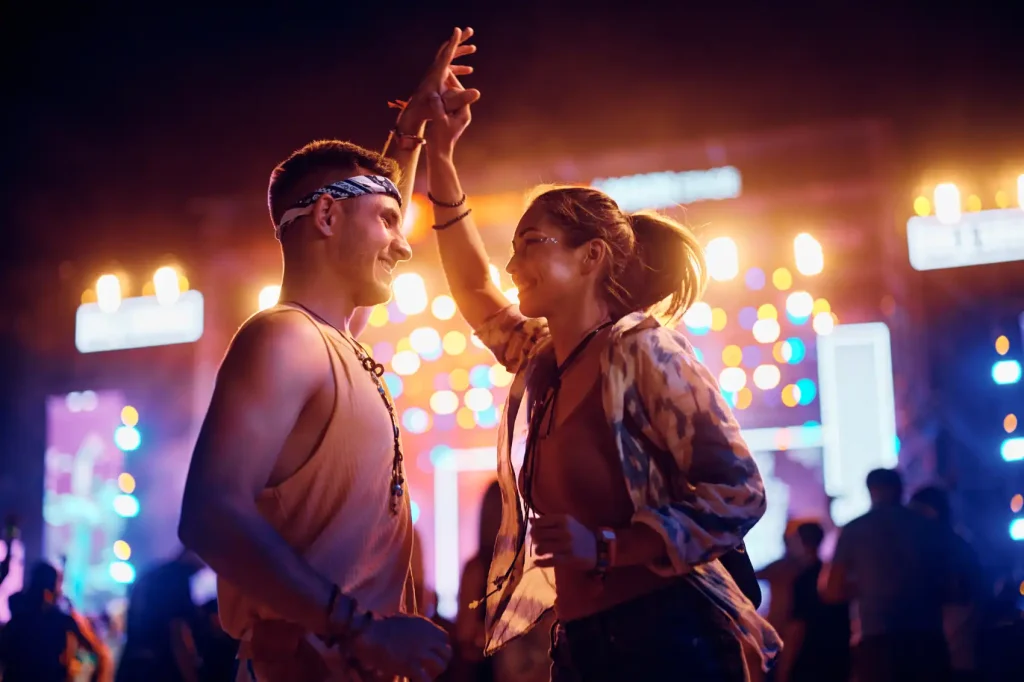 young couple at the festival waiting for a taxi